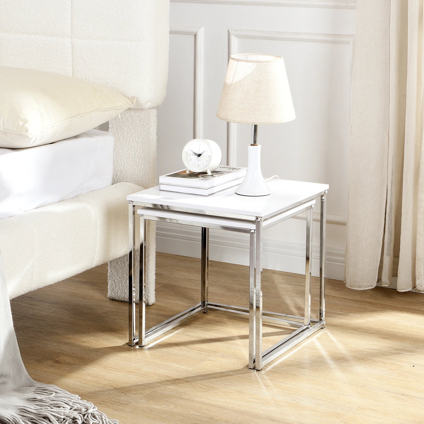 This modern nesting coffee table set features a sleek white high-gloss finish and a durable metal frame. Its space-saving, detachable design is versatile for any living room, office, or compact space.