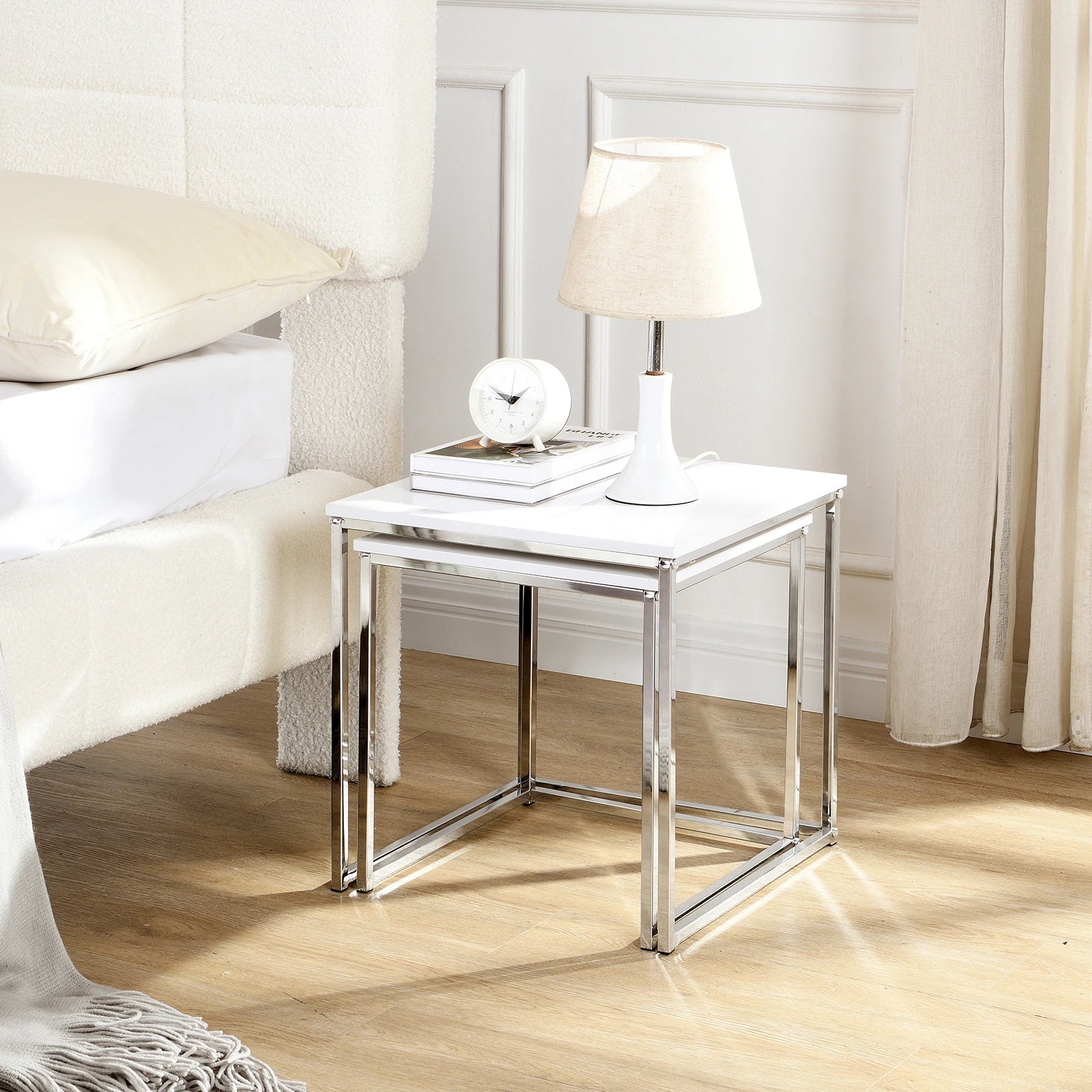 This modern nesting coffee table set features a sleek white high-gloss finish and a durable metal frame. Its space-saving, detachable design is versatile for any living room, office, or compact space.